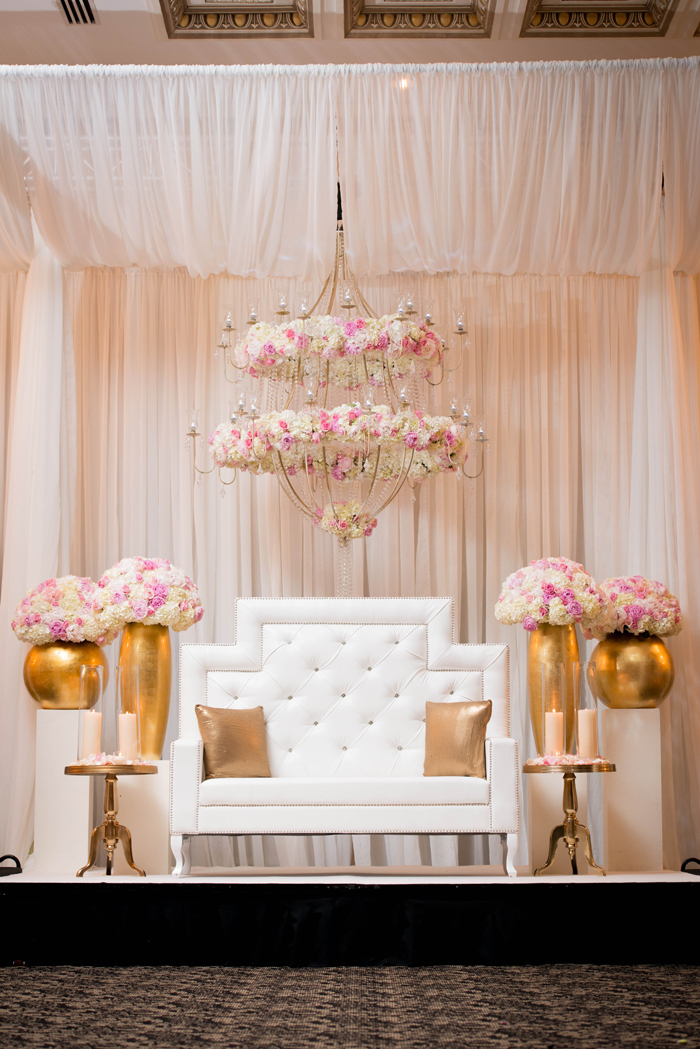 Custom floral chandelier with white and gold head table. See more at Rebecca Chan Weddings and Events http://www.rebeccachan.ca