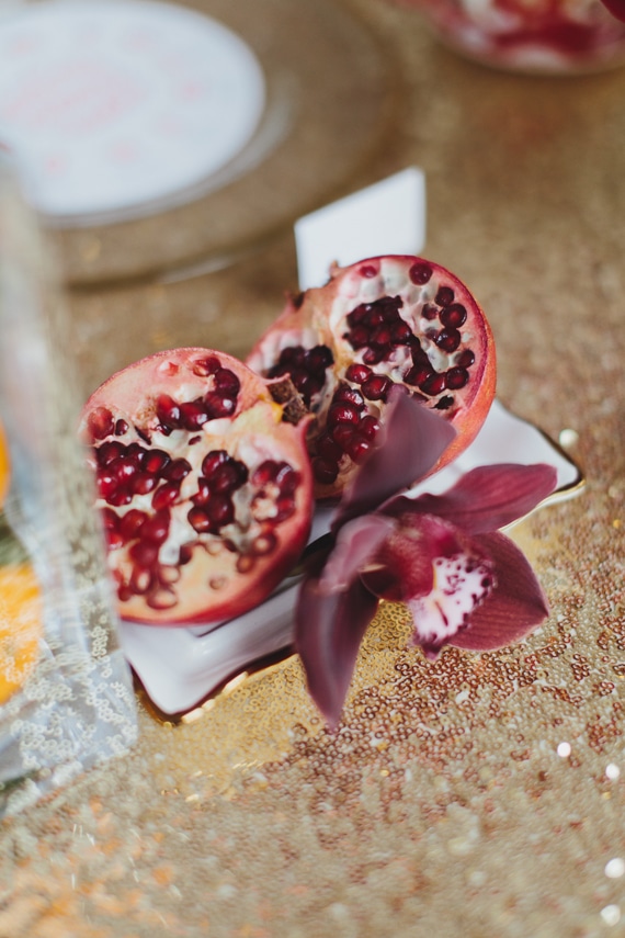 Decorate with pomegranates for a fragrant and fresh take on decor. Chic Gold and Red Chinese New Year Dinner Party ideas at www.rebeccachan.ca