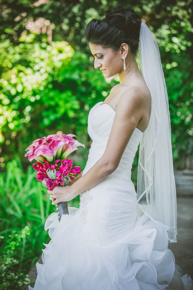 Bride and her dramatic pink bouquet made of calla lillies and gloriosa lillies. To see more of this modern wedding, visit Rebecca Chan Weddings and Events http://www.rebeccachan.ca