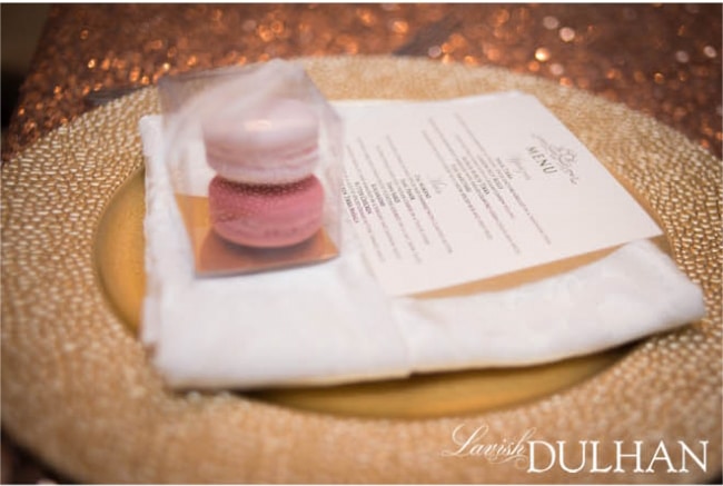 Gold place setting with pink macaron favours. See more at Rebecca Chan Weddings and Events http://www.rebeccachan.ca
