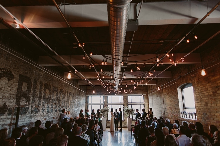Ceremony - Intimate Burroughes Building wedding with string lights and lavender