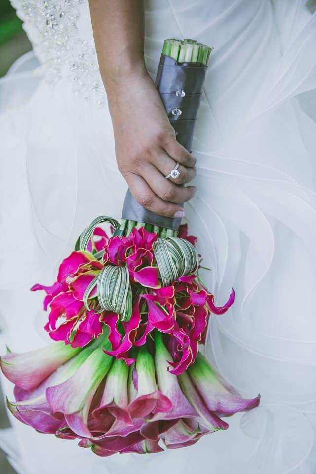 Bride's fuschia pink bouquet with calla lilies and gloriosa lilies. To see more of this modern wedding, visit Rebecca Chan Weddings and Events https://www.rebeccachan.ca