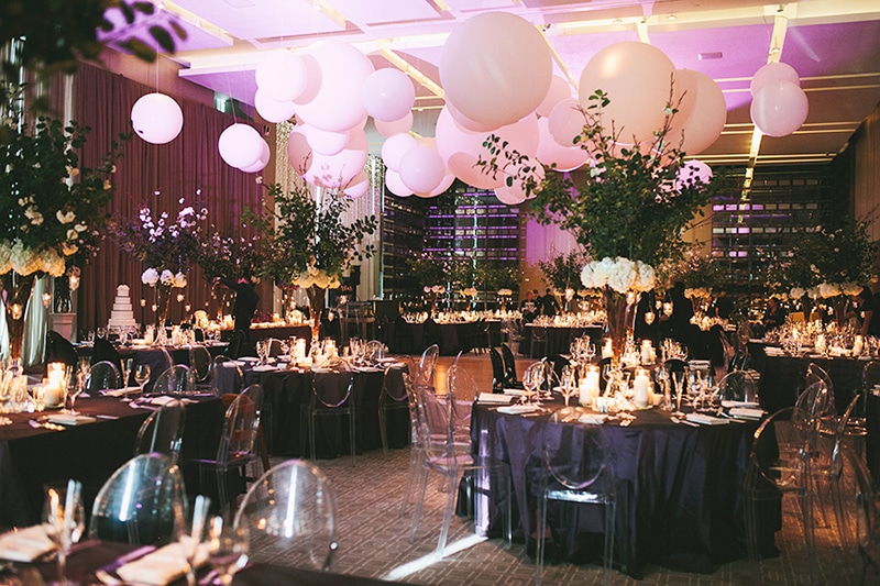 A modern black-tie affair with balloon installation above the dance floor and purple accents, as seen in Wedluxe. Planner: Rebecca Chan Weddings and Events www.rebeccachan.ca To see more, visit www.rebeccachan.ca