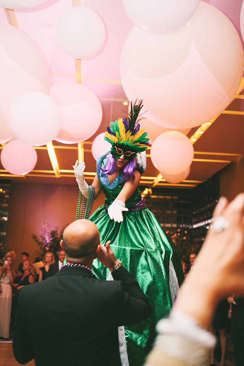 Stilt walkers hand out masks and beads at this wedding reception, as seen in Wedluxe. Planner: Rebecca Chan Weddings and Events www.rebeccachan.ca To see more, visit www.rebeccachan.ca