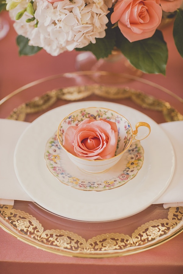 Cute floral tea cups on gold chargers. Coral and Gold Wedding Inspiration - See more at Rebecca Chan Weddings and Events www.rebeccachan.ca