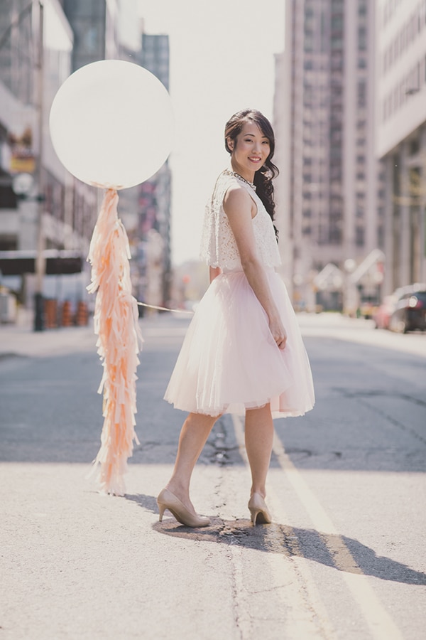 Coral and Gold Wedding Inspiration - Urban portrait with balloon and tassels. See more at Rebecca Chan Weddings and Events www.rebeccachan.ca