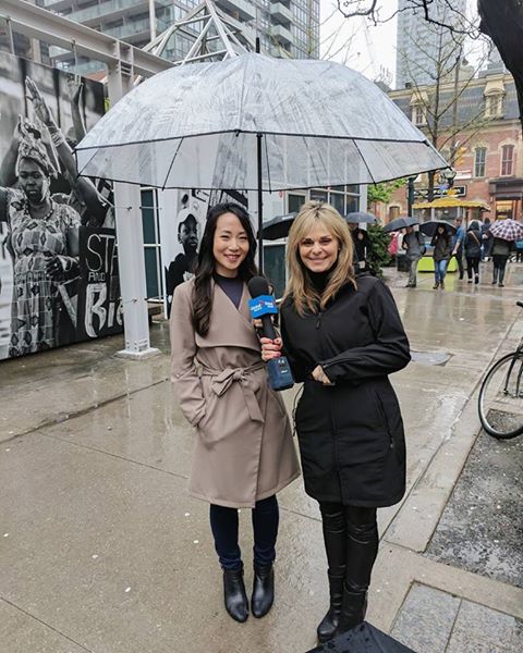 Sharing rainy wedding tips under my wedding umbrella with Susan Hay from Global