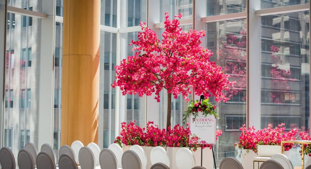 Fuschia and red bouganvillea tree decor from Rachel A. Clingen and white Louis chairs at Shangri-La Toronto