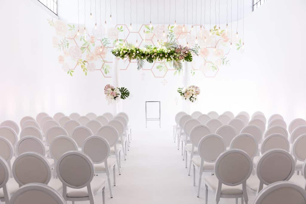 Modern Industrial Wedding Ceremony with Wall Vinyl and Hanging String Lights at District28