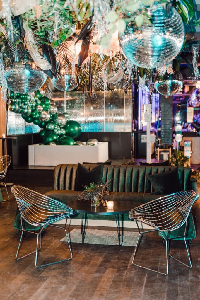 Disco ball and tropical greenery ceiling installation at Rupi Kaur's 30th birthday party; Planned by Toronto event planner, Rebecca Chan Events 