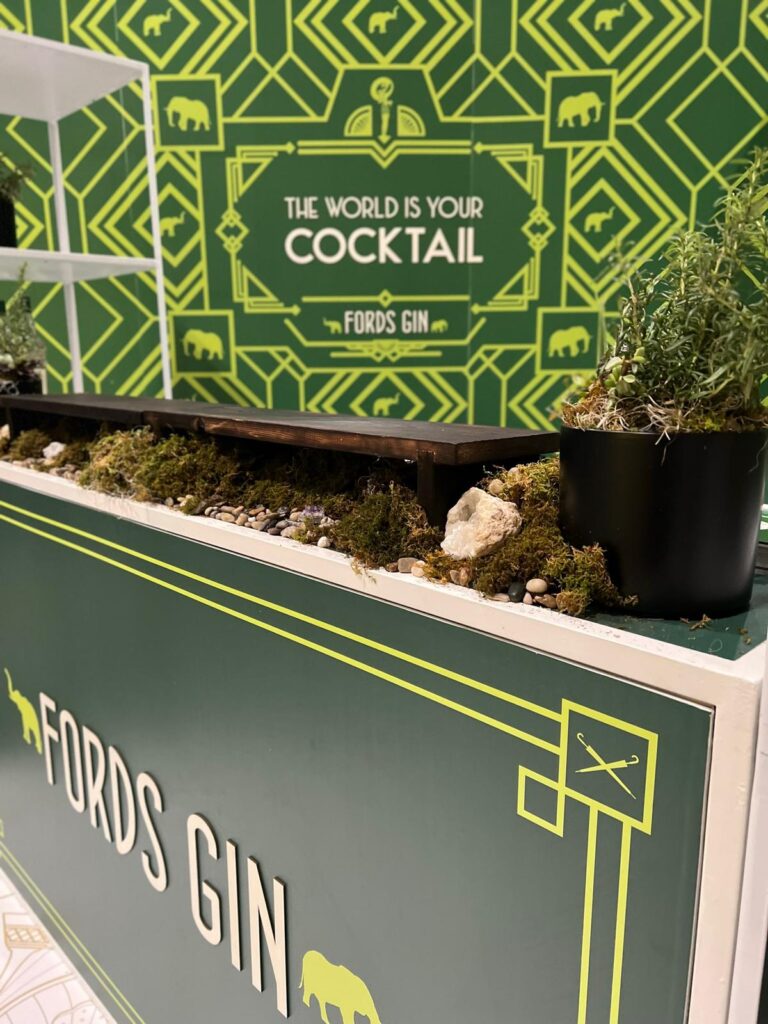 Toronto trade show booth design for Fords Gin - Bold graphics with rustic decor elements for visual interest